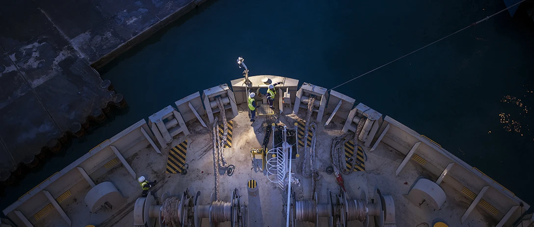 A ship’s bow seen from above in a dry dock at night