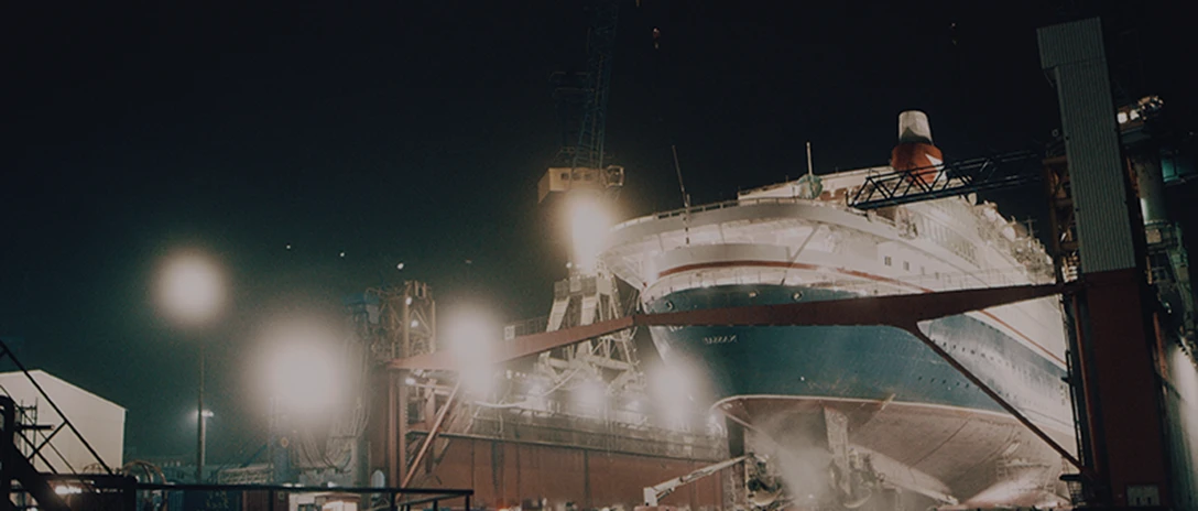 A ship’s bow seen from above in a dry dock at night