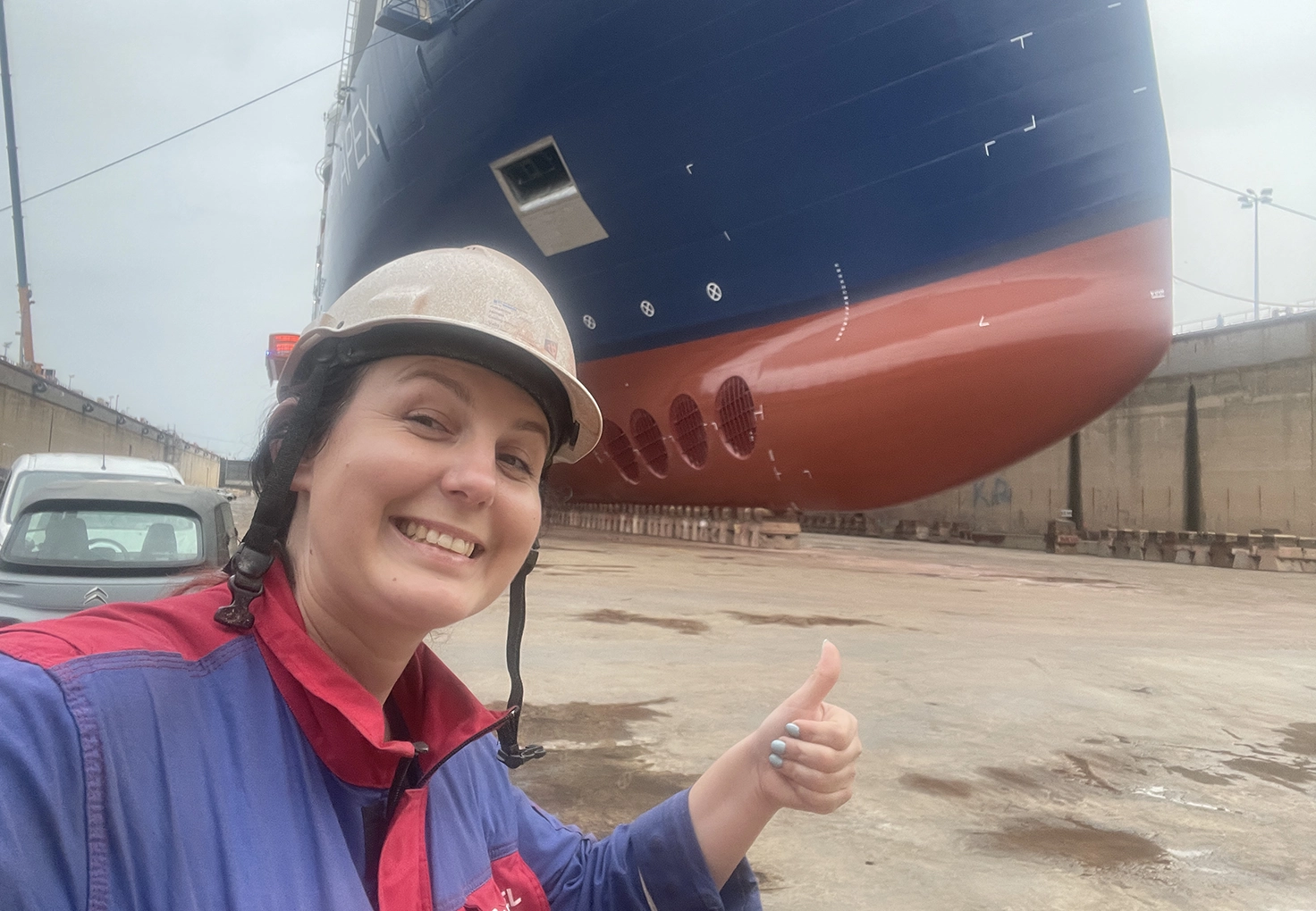 Advisor smiling with big vessel behind