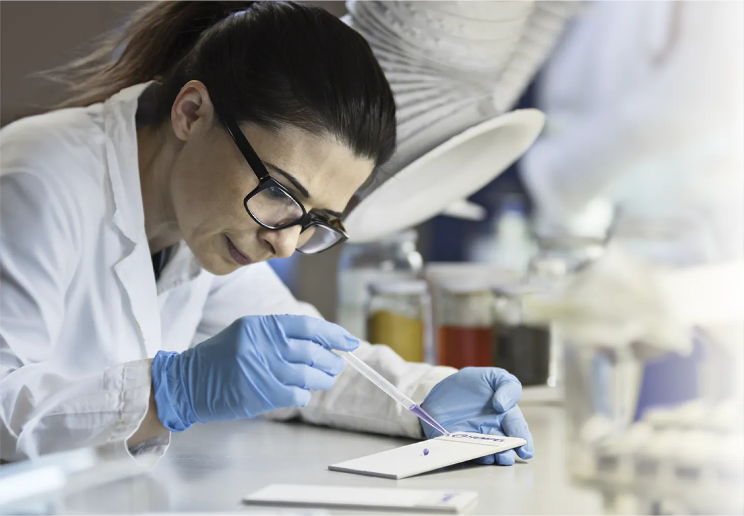 Woman in laboratory making a sample
