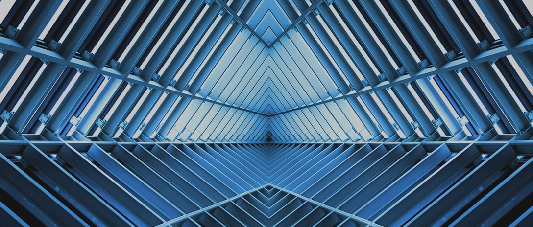 A geometric pattern of intersecting metal beams forming a symmetrical, futuristic structure in shades of blue.