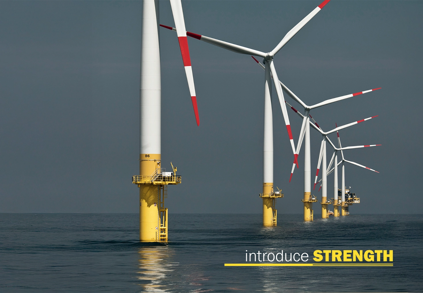 Offshore wind turbines in a row with the words “introduce STRENGTH” overlaid.