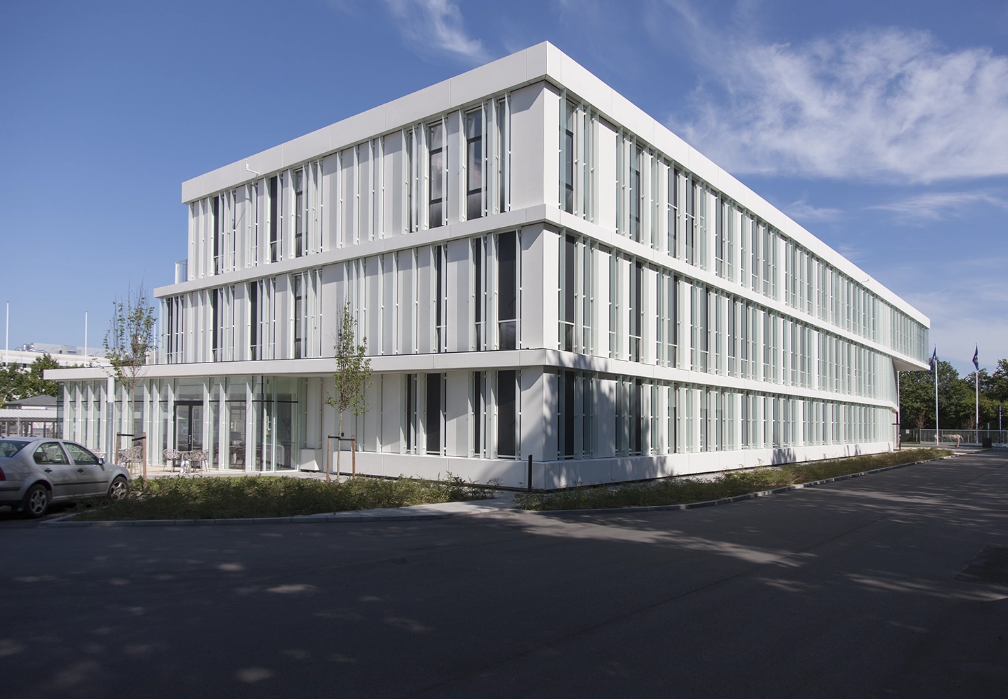 Exterior view of the Hempel headquarters building, showcasing its modern white design with large windows.