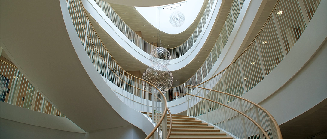 Spiraling staircase and spherical chandeliers inside the Hempel headquarters.