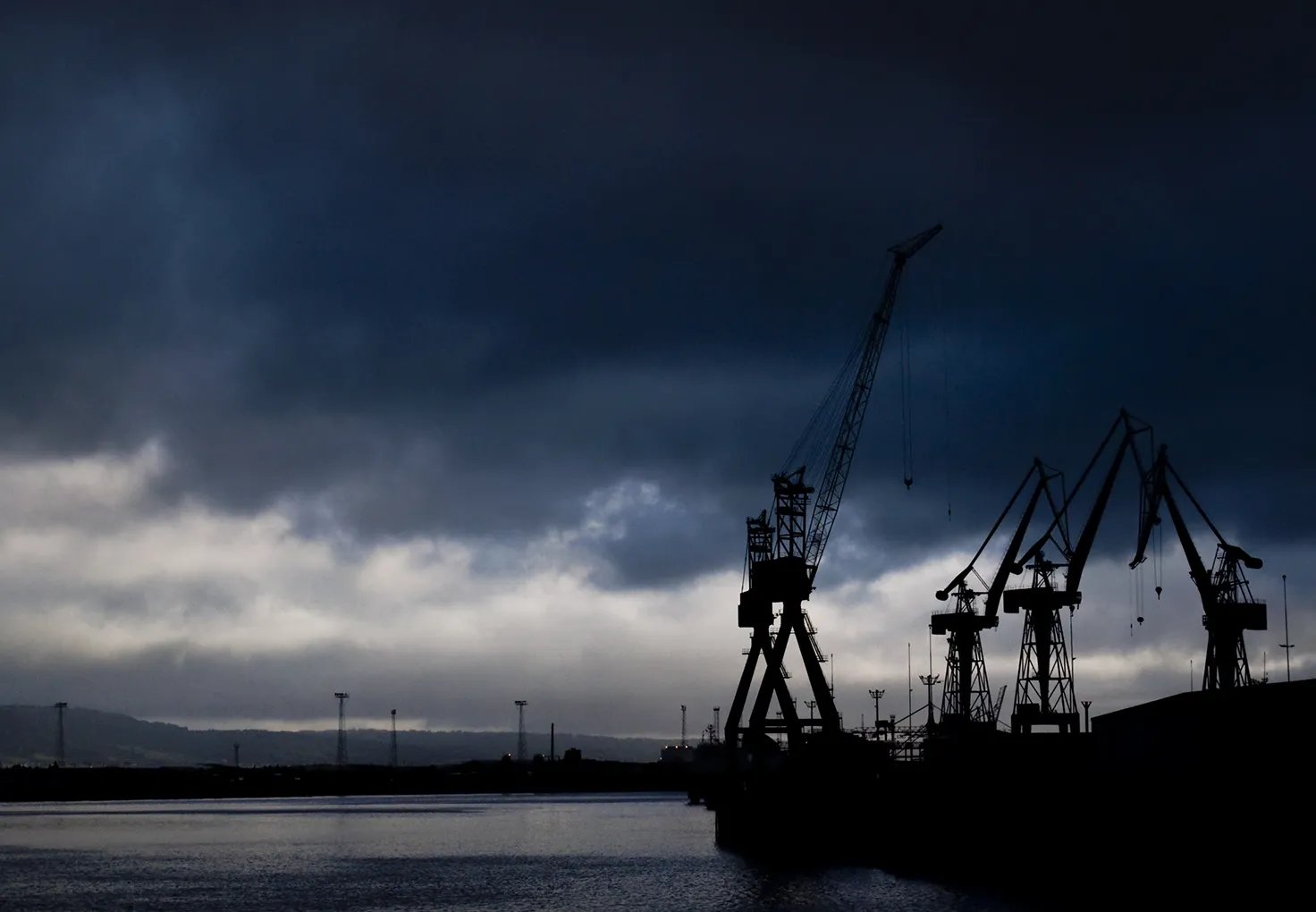 Port siluettes with dark clouds