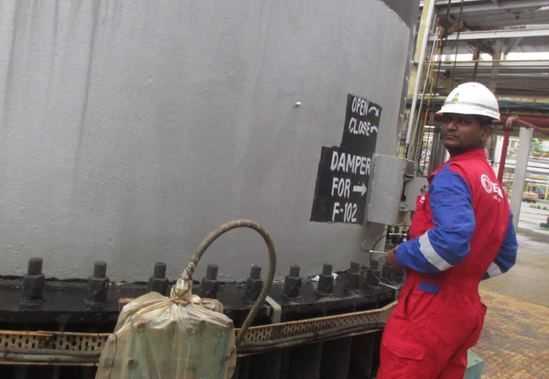 A Hempel coating advisor at the BPCL refinery inspects equipment coated with Hempaprime CUI 275 for corrosion protection.