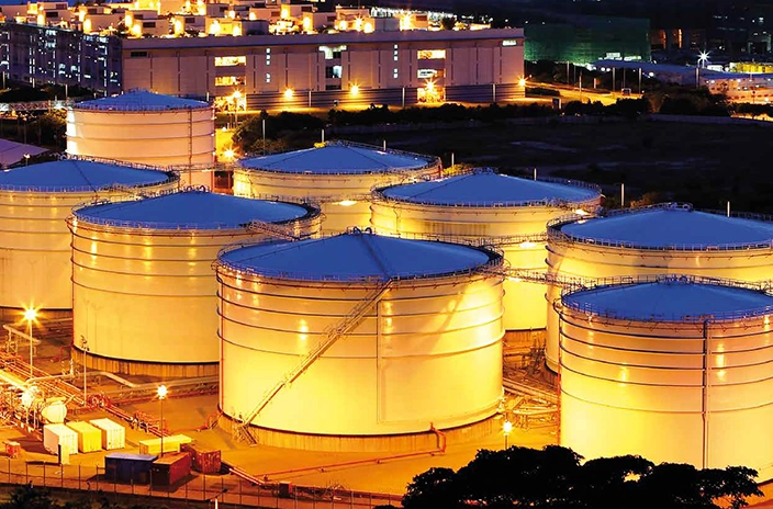 Fuel storage tanks at Shell Nederland's depot in Arnhem illuminated at night.