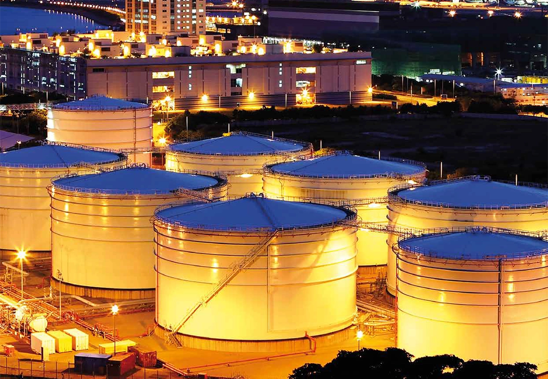 Fuel storage tanks at Shell Nederland's depot in Arnhem illuminated at night.