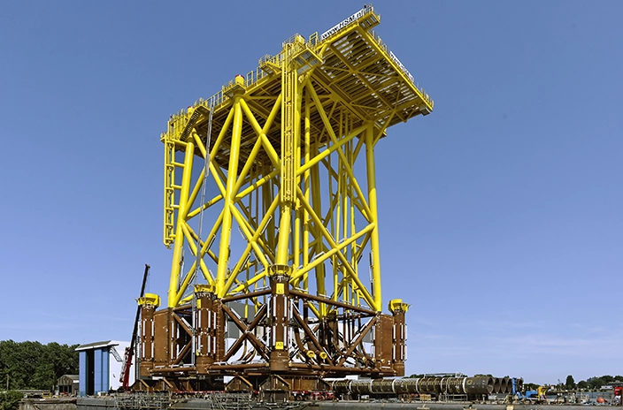 TenneT company's offshore wind platform structure painted yellow.