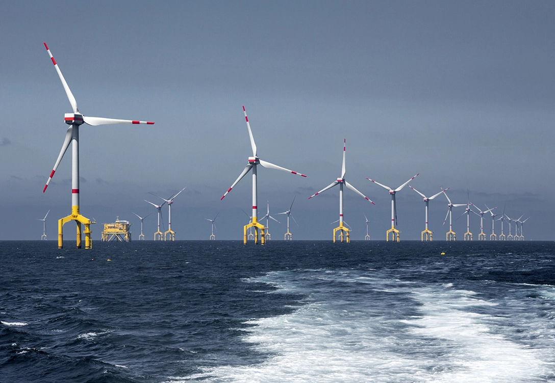 A wide view of several wind turbines at the offshore wind farm in china sea.