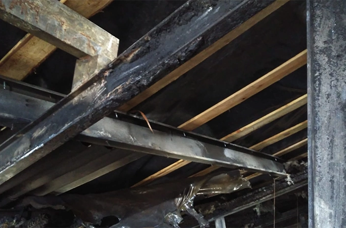 Beam burned by fire.