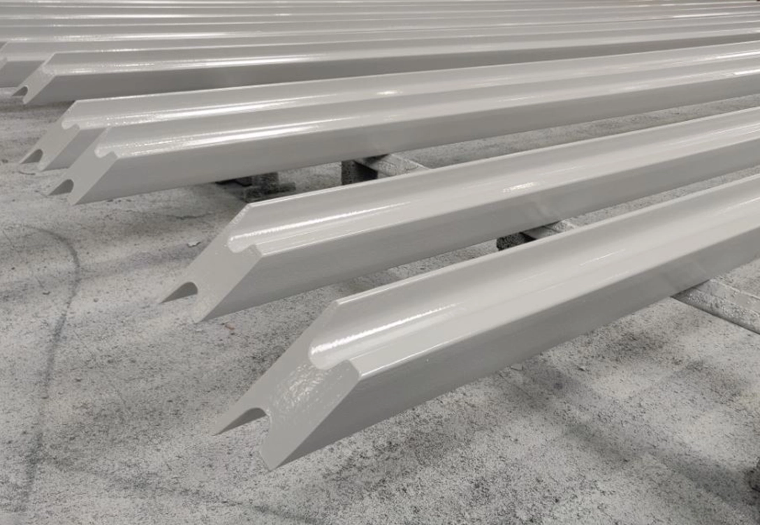 Steel beams coated with Hempadur Multi-Strength 35840, a durable glass-flake reinforced coating, applied by SSWI for corrosion protection in C5 environments.