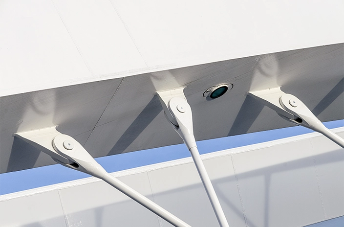 A close-up view of the structural connections on Troja Bridge, showing the white tension cables attached to the bridge’s surface.