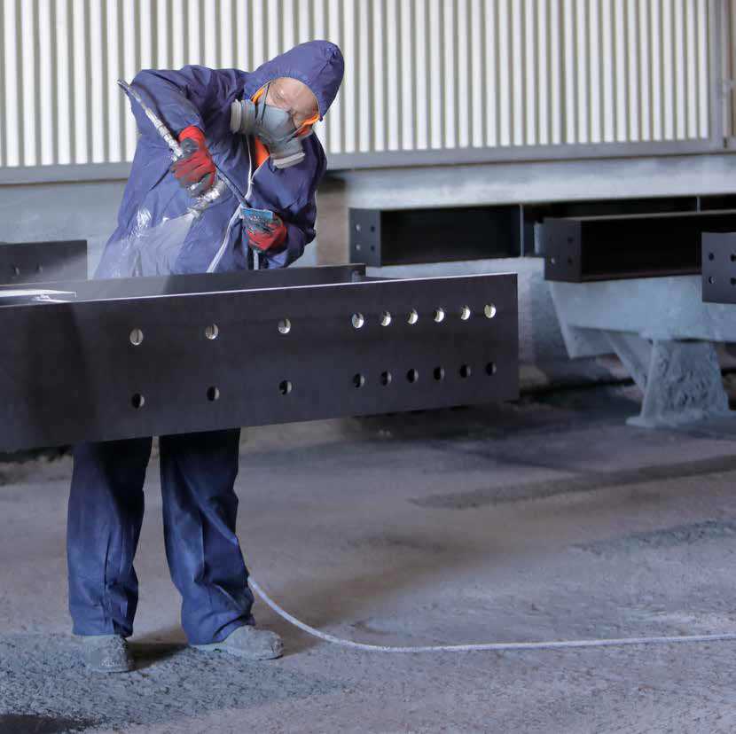 A Vale Protective Coatings worker applies Hempafire Pro 315 Fast Dry intumescent coating to a steel beam during a trial to improve productivity and maintain quality.