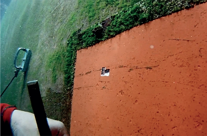 An underwater view shows a heavily fouled section next to a clean Hempaguard-coated area on the ship's hull.