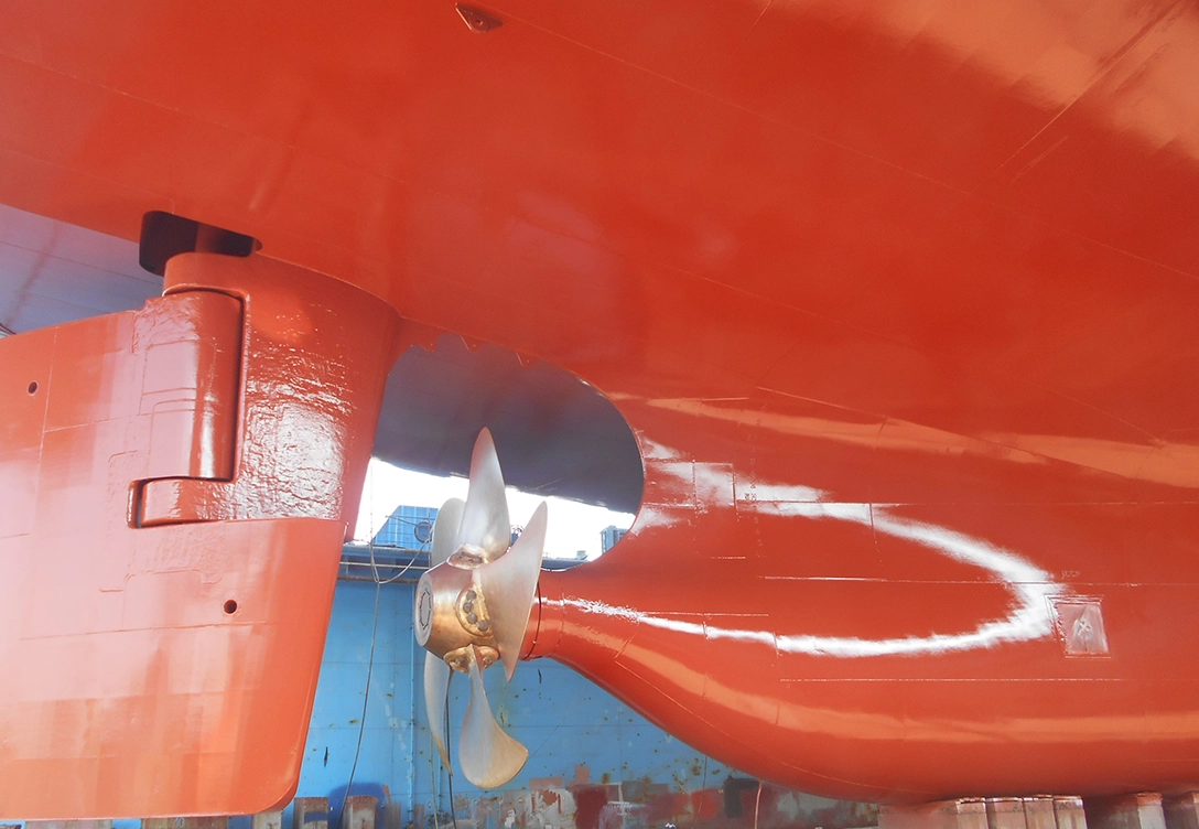 A close-up view of the Neptune Lines vessel's red hull, coated with Hempadur Quattro and Hempaguard X7.