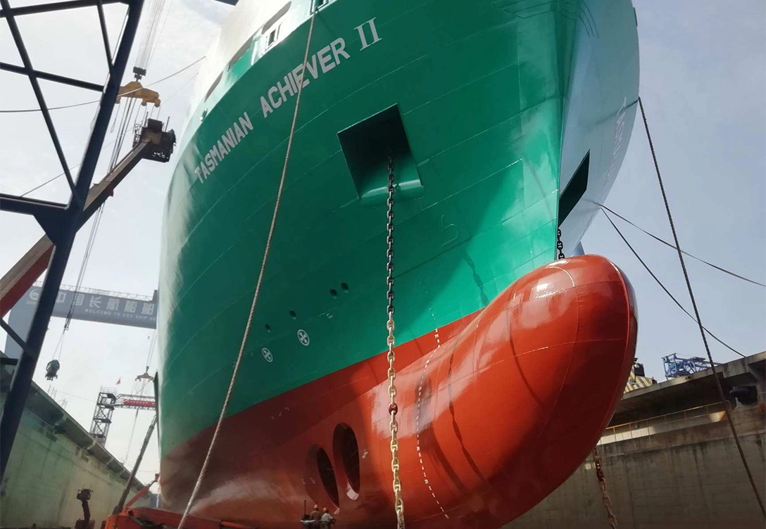 The "Tasmanian Achiever II" from Toll Shipping in a dry dock, with its teal and red hull