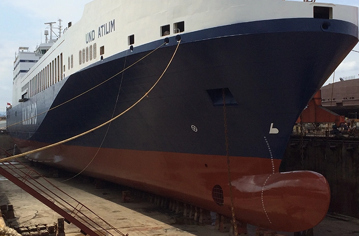 U.N. Ro-Ro vessel with a blue and red hull coated by Hempel's Hempaguard X7 coating.