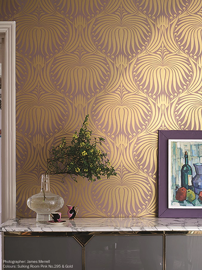 A textured wall covered in patterned wallpaper featuring floral designs in soft colors.
