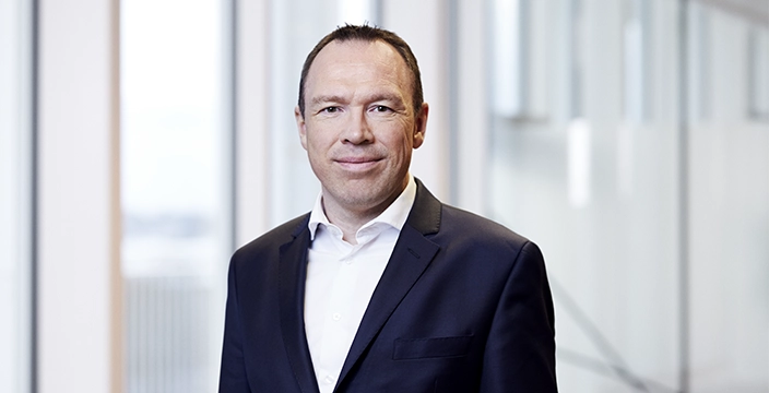 Michael Hansen, President & Chief Executive Officer at Hempel in a suit.