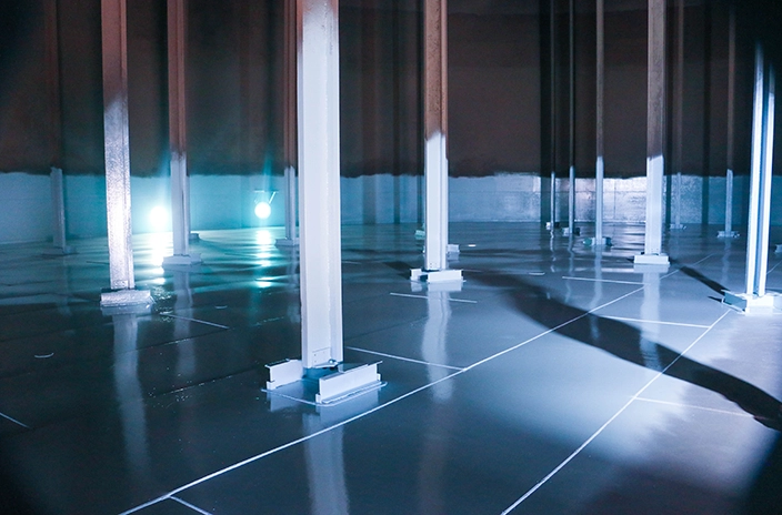 The interior of a storage tank at Oldelval, a leading midstream storage and transportation company in Argentina, with steel support beams and a reflective coated floor.