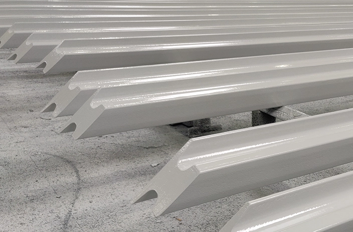 Steel beams coated with Hempadur Multi-Strength 35840, a durable glass-flake reinforced coating, applied by SSWI for corrosion protection in C5 environments
