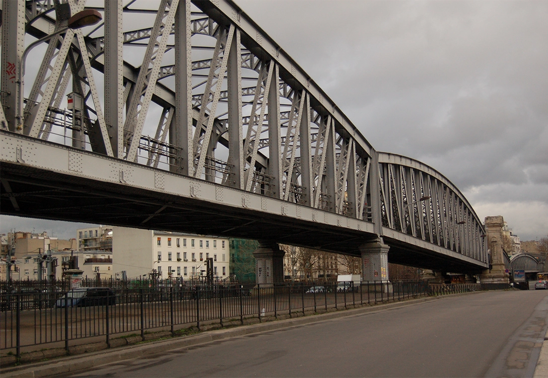 A steel viaduct, part of the RATP rail network, spans over a road in an urban area.
